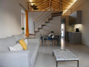 a living room with a couch and a table and a staircase at TH Studio in Myrina