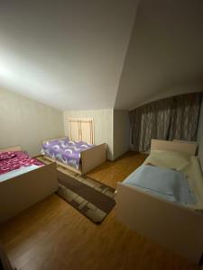 two beds in a room with boxes in it at Rustaveli 106 in Kutaisi