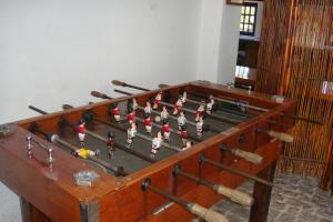 a wooden foosball table with balls and bats on it at Casa da Malta do Monte dos Arneiros in Lavre