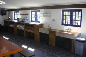 a kitchen with wooden counters and a sink at Casa da Malta do Monte dos Arneiros in Lavre