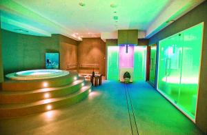 a lobby with a large room with stairs and green lights at I 13 Cavalieri Guest House in Barletta