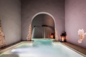 a swimming pool with an archway in a room at Sant Pere del Bosc Hotel & Spa - Adults Only in Lloret de Mar