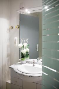 a bathroom with a sink and a mirror at Hotel Abat Jour in Nantes +42 photos