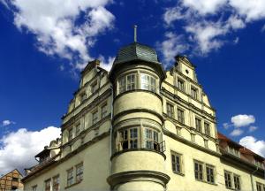 a building with a tower on top of it at Wyndham Garden Quedlinburg Stadtschloss in Quedlinburg