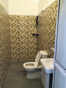 a bathroom with a toilet and a sink at Kangar Jaya Lodging in Kangar