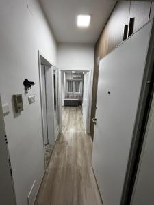 an empty hallway with white walls and wooden floors at Stefanoski Apartments in Skopje