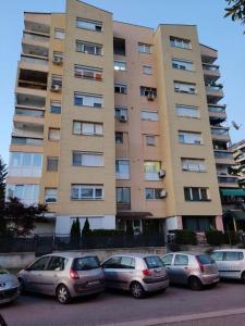 a group of cars parked in front of a building at Stefanoski Apartments in Skopje