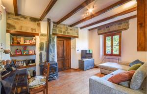 a living room with a couch and a fireplace at Amazing Home In Tiglieto With 4 Bedrooms in Tiglieto