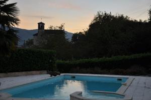 a swimming pool in the backyard of a house at La Bourgeat in Chantesse