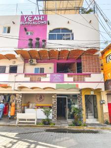 a building with a bench in front of it at Bungalows Yeah Los Ayala in Los Ayala