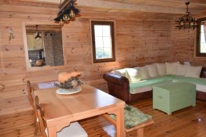 a living room with a couch and a table at Vila Bridge Tara in Pljevlja