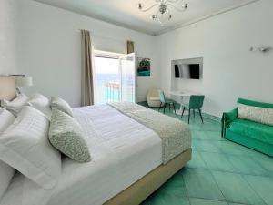 a bedroom with a bed and a table and a window at Casa Adelaide in Capri