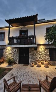 un edificio con dos bancos delante en Villa Prespa, en Dolno Dupeni