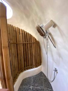 a bathroom with a hair dryer on the wall at Adorable Dome House in Puerto Princesa City