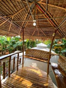 - une terrasse couverte avec 2 lits sous un toit de paille dans l'établissement Adorable Dome House, à Puerto Princesa