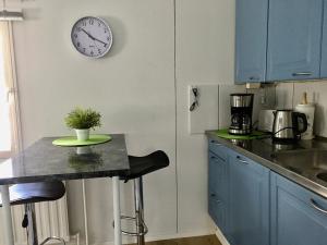a kitchen with a counter and a clock on the wall at Aurora Center 3 in Rovaniemi