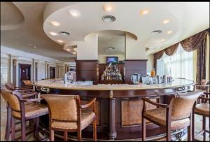 a bar in a room with a bunch of chairs at Sunset Resort Apartament C3 - 22 in Pomorie