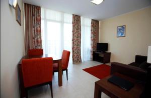 a living room with a table and a couch at Sunset Resort Apartament C3 - 22 in Pomorie