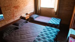 Cama ou camas em um quarto em Nosso Recanto Gaúcho Paraíso no interior Guaratinguetá Aparecida