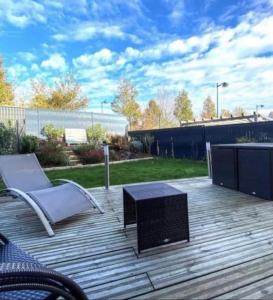 un patio avec deux chaises et une table sur une terrasse dans l'établissement Logement exceptionnel avec jardin proche Disney, à Montévrain