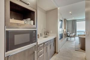 a kitchen with a sink and a microwave at Platinum Room Hotel Room in Park City