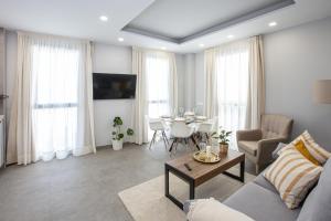 Apartamentos Ribera 19 في قرطبة: غرفة معيشة مع أريكة وطاولة