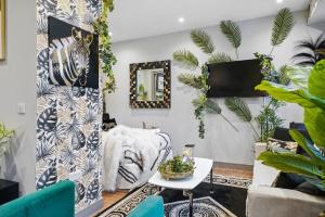 a living room with a zebra picture on the wall at Boho Jungle - Luxury 1bed Apt- Long stay Discounts in Kent