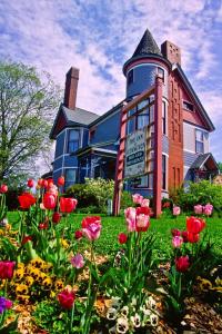 a large building with flowers in front of it at The Fresh Coast Inn at Ludington in Ludington