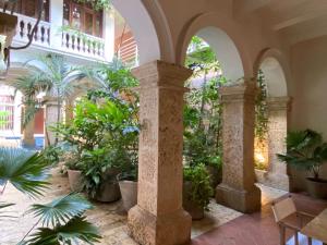 a courtyard with plants in a building at Sophisticated 4BR House with Pool in Cartagena in Cartagena de Indias