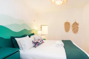 a bedroom with a large bed with white pillows at Alfama Patio Apartments in Lisbon