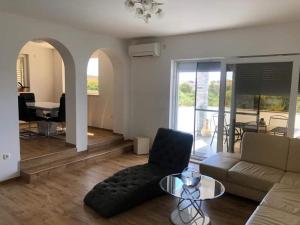 a living room with a couch and a glass table at Apartament Maja in Rogoznica