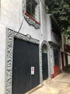budynek z czarną bramą i oknem w obiekcie Espectacular Loft en la Condesa cama King Size w mieście Meksyk