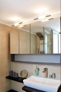 a bathroom with a sink and a mirror at Luxury at its best beach condo in Palaio Faliro in Athens