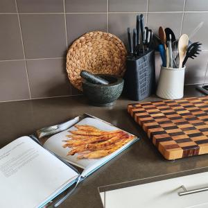 a kitchen counter with a plate of food and a book at Maggie's Place in Cowes in Cowes