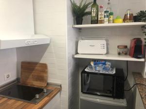 a kitchen with a sink and a toaster oven at Apartment At The Beach -La Malagueta-Free Parking- in Málaga