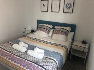 a bedroom with a bed with towels on it at Apartment At The Beach -La Malagueta-Free Parking- in Málaga