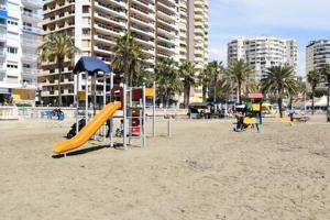 a playground on the beach with slides and condos at Apartment At The Beach -La Malagueta-Free Parking- in Málaga
