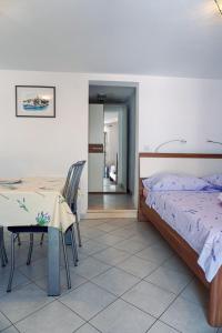 une chambre avec un lit, une table et des chaises dans l'établissement Apartments by the sea Lumbarda, Korcula - 9325, à Lumbarda