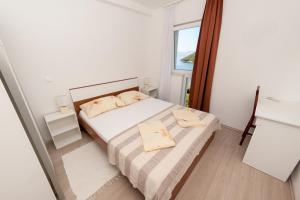 a small bedroom with a bed and a window at Apartments by the sea Prozurska Luka, Mljet - 9446 in Prožura
