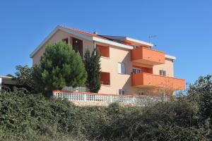 a house on a hill with trees in front of it at Apartment Vlasici 9324c in Vlašići