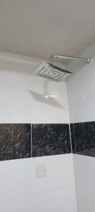 a glass shelf with a paper on top of a wall at Premium 3 Bedroom Villa Upscale Alagbaka Area in Akure +36 photos