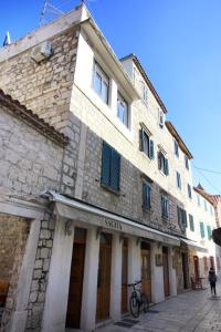 an old stone building on a city street at Apartments with WiFi Omis - 9460 in Omiš