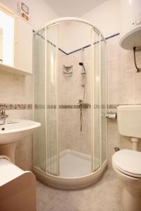 a bathroom with a shower with a toilet and a sink at Apartments with WiFi Omis - 9460 in Omiš