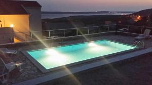 a swimming pool on top of a house at night at Studio Zubovici 9365a in Zubovići