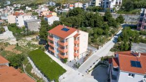 an aerial view of a building with solar panels on its roof at Apartments with a parking space Duce, Omis - 9437 in Dugi Rat