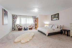 a bedroom with a large bed and a large window at Luxurious Spacious Dream Home in Richmond Hill