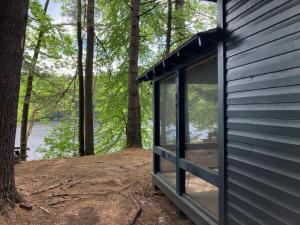 a large glass window on the side of a house at Camp Hudson Pines in Corinth