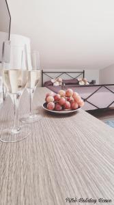 a plate of food on a table with two wine glasses at pitrè holiday house in Palermo