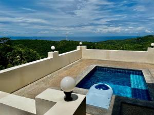 a swimming pool on the roof of a house at Koh Tao Studios 47 in Ko Tao