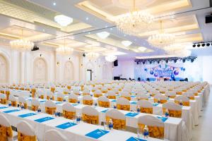 a large banquet hall with white tables and chairs at Cantho Eco Resort in Can Tho